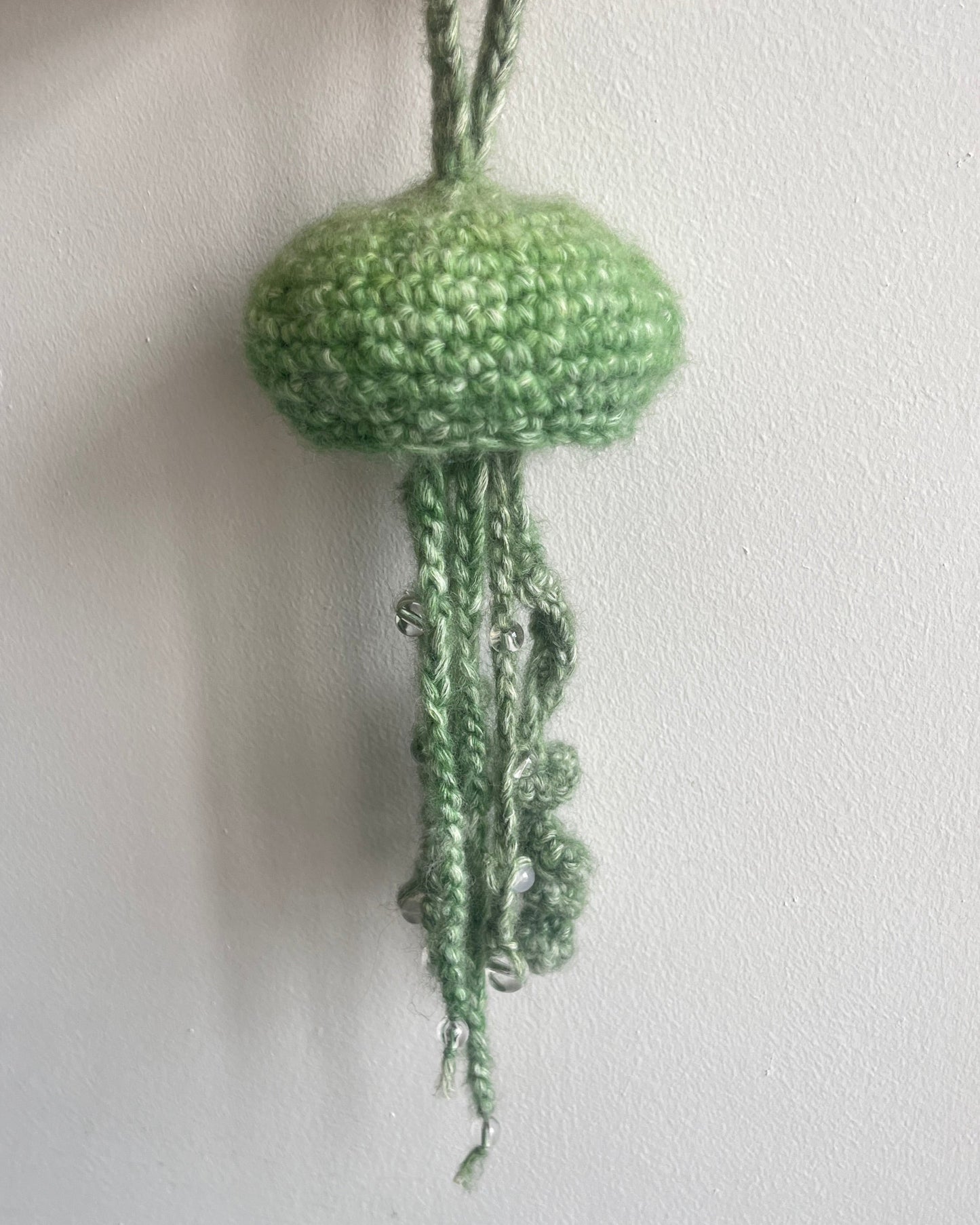green jellyfish with beads